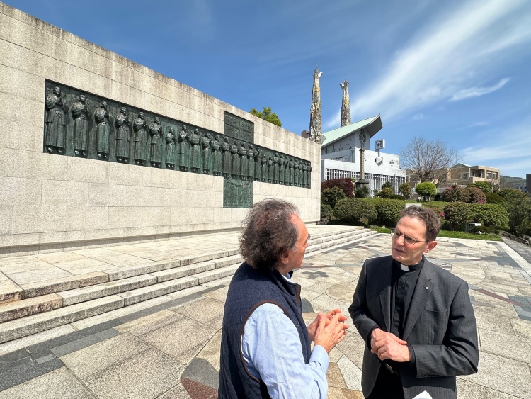 Author and Father Renzo de Luca in front of the 26 Martyrs Museum in Nagasaki, Japan. The museum was built 1962 to commemorate the 26 Christians who got executed for preaching Christianity on the Nishizaka hill in 1597. Photo: Katsuhiro Asagiri, President of INPS Japan.