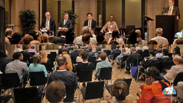 Photo: Chair (on podium), four panelists and a section of the audience of the Forum on "A World Free of Nuclear Weapons is Possible" on 11 September 2023 in Berlin held as part of the International Meeting "The Audacity of Peace" hosted by the lay Catholic Association Community of Sant’Egidio. The Forum was co-organized by Soka Gakkai and others. Credit: Sant'Egidio.